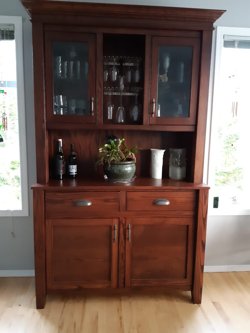 Solid wood dining hutch with glass upper cabinets, a wine glass rack, and lower storage drawers
